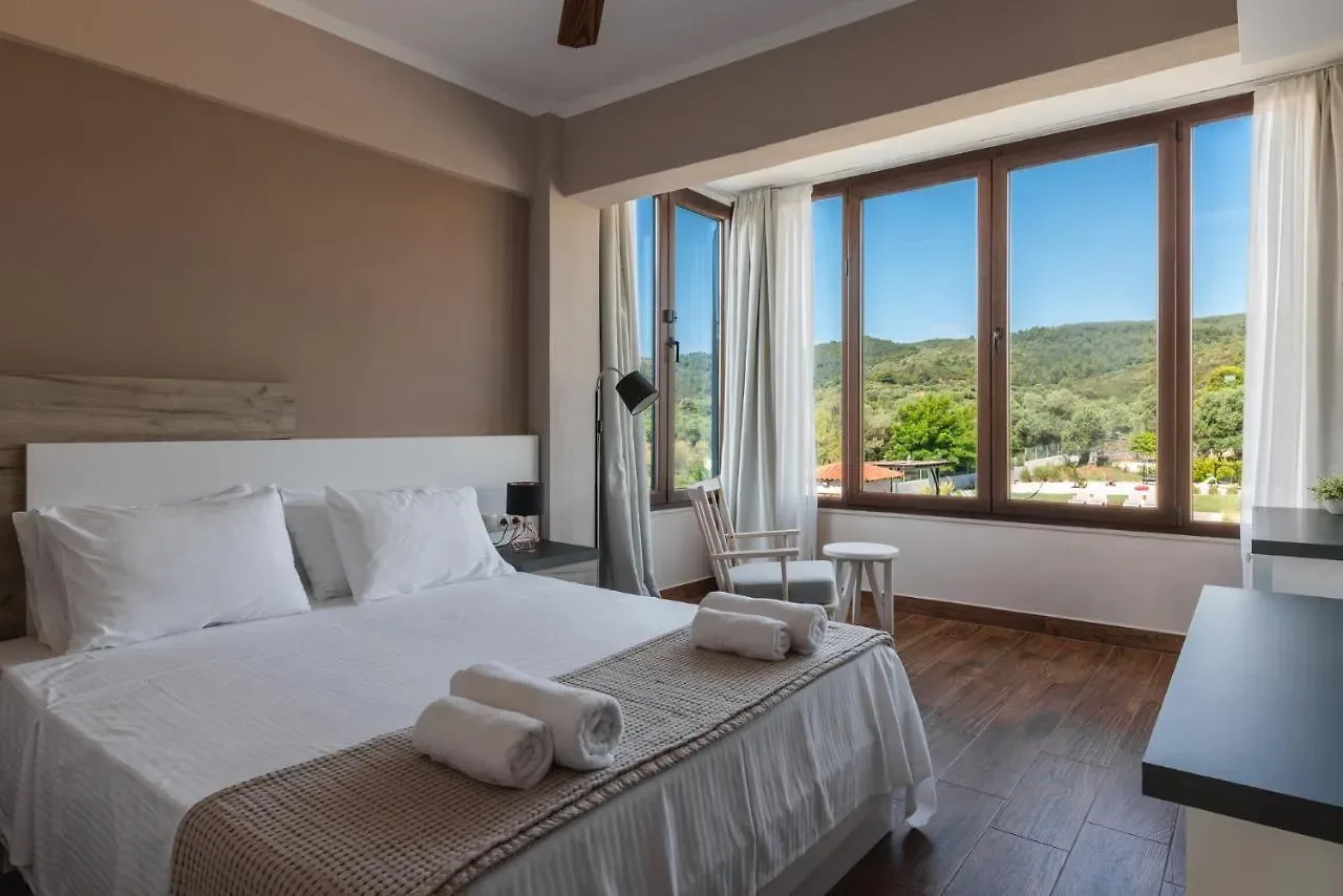 King bedroom with a corner window over the olive hills