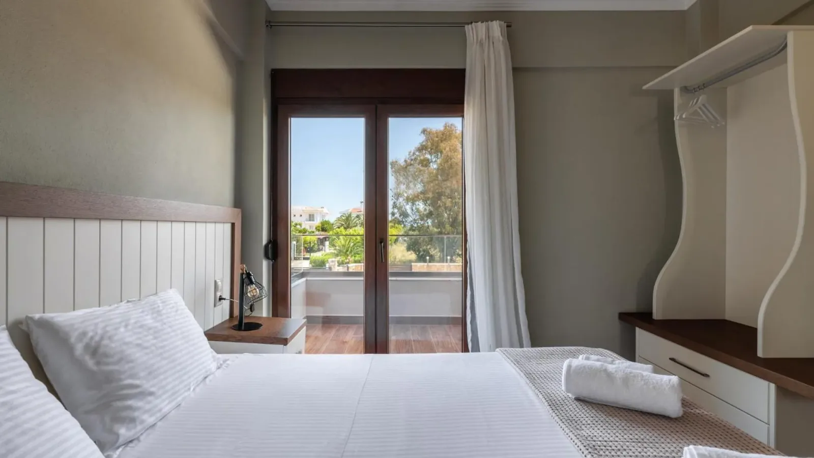 King bedroom with French doors to a private balcony