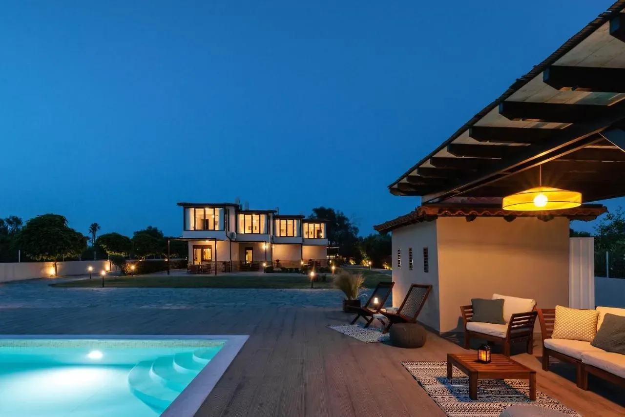 The pool and the villas at dusk