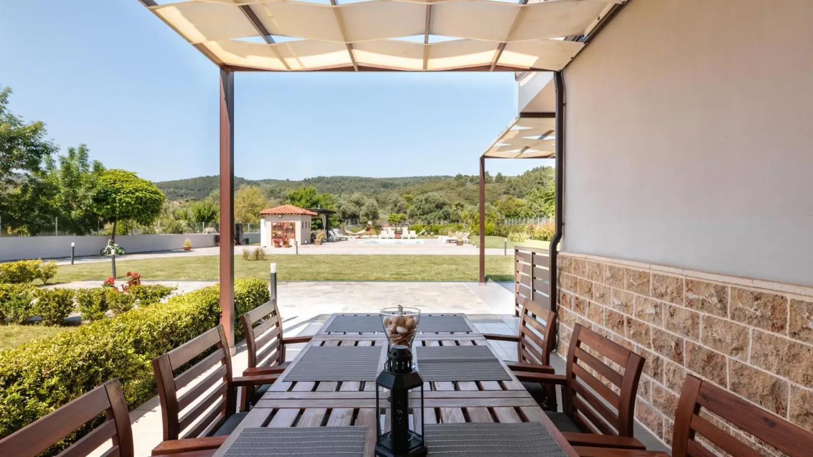 Terrace table looking down the lawn to the pool